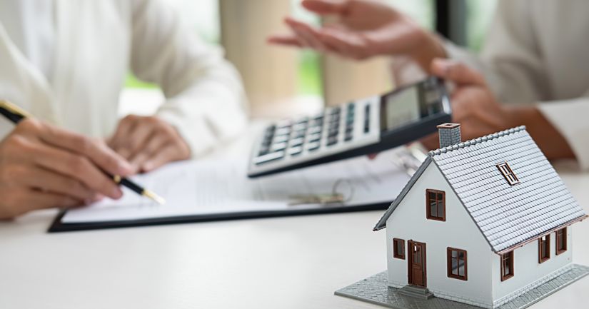 credit scores and mortgage - calculator and paperwork image